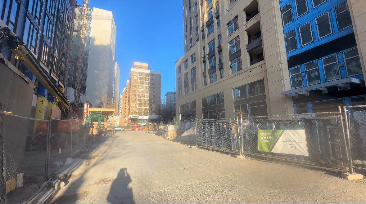 Silhouette photographing new buildings around the construction site of Purple Line in Bethesda