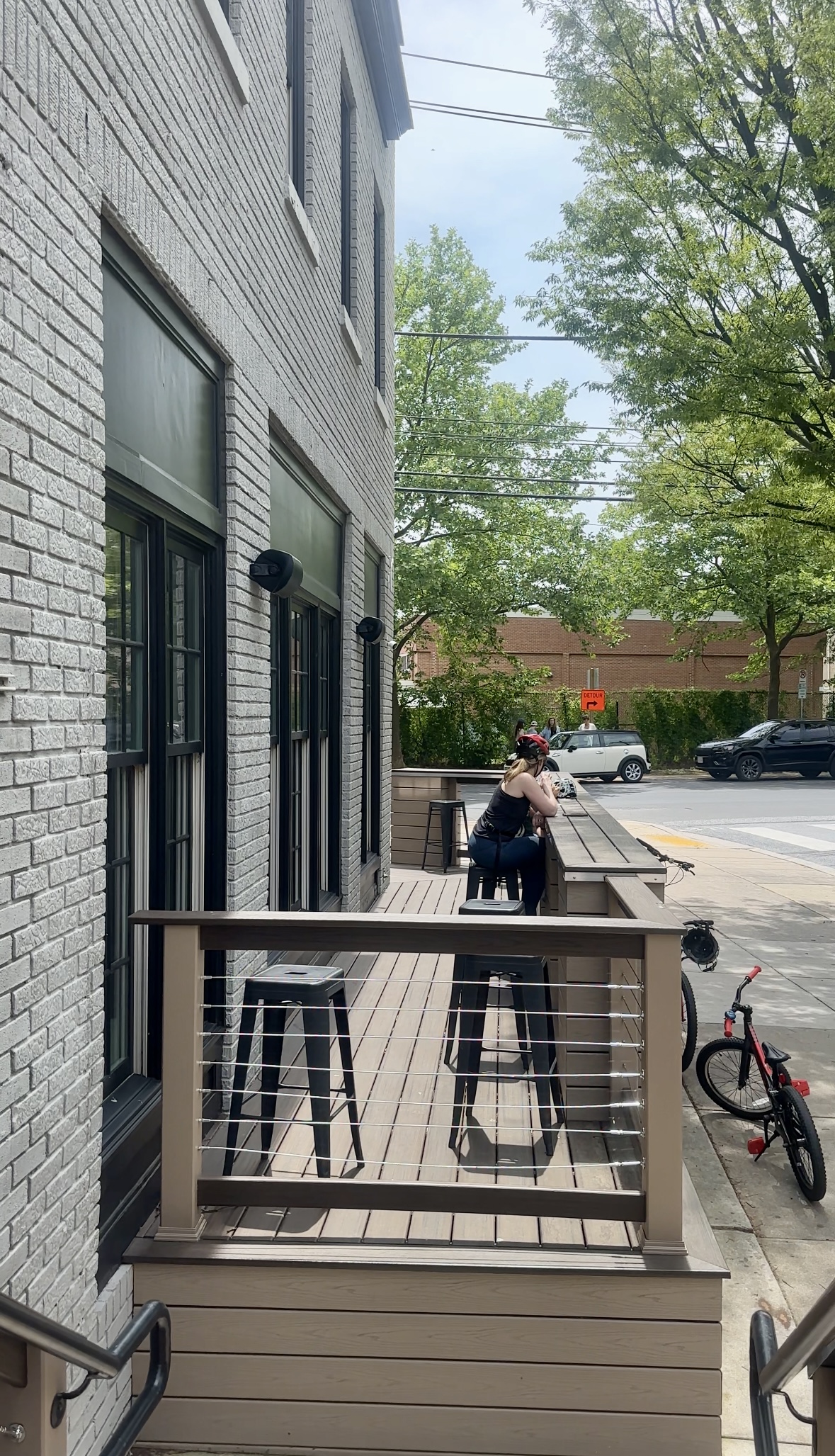 Small deck seating where locals sip espresso and chat under the trees.
