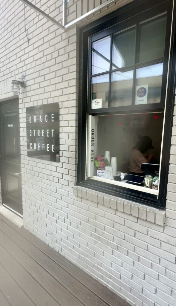 Barista preparing coffee order at Bethesda cafe window