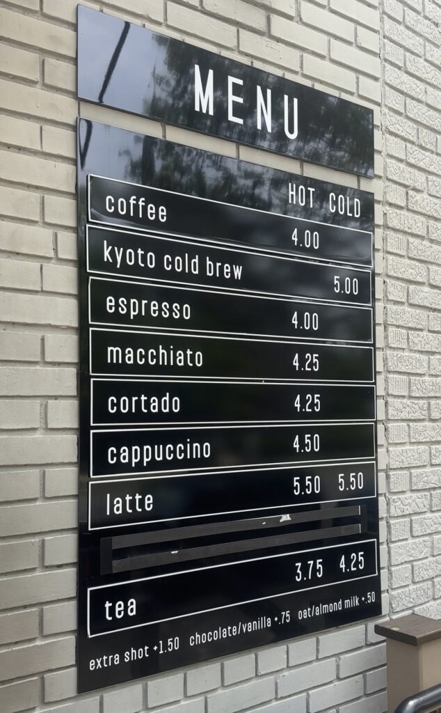 Grace Street Coffee Roasters menu sign on brick wall.