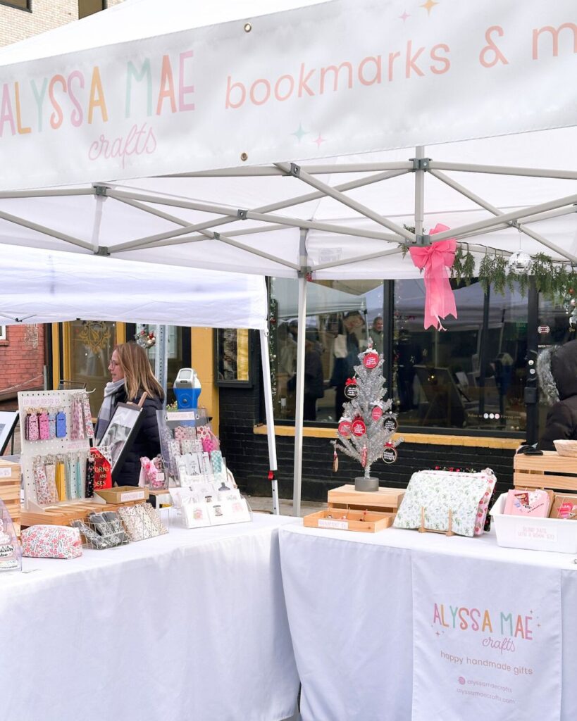 Alyssa Mae Crafts booth with handmade bookmarks, ornaments, and giftable pouches.