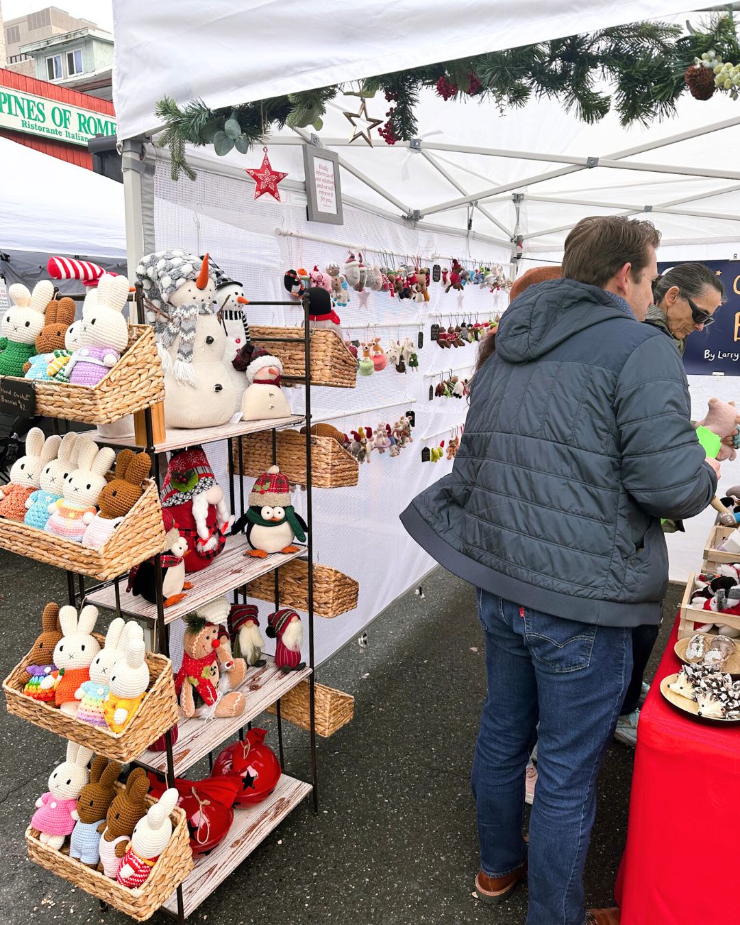 Crocheted bunnies, snowmen, and garland lining vendor booth.