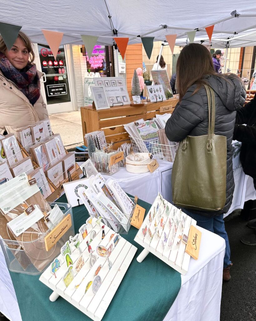 D. Prince Designs display with illustrated greeting cards and art prints for sale.