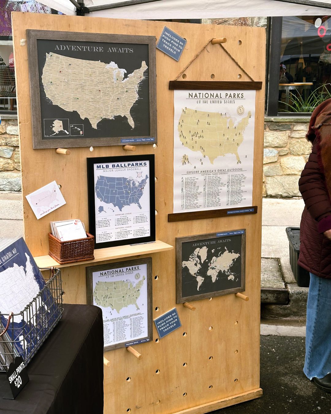 Wood panel wall with framed travel maps and national parks poster.