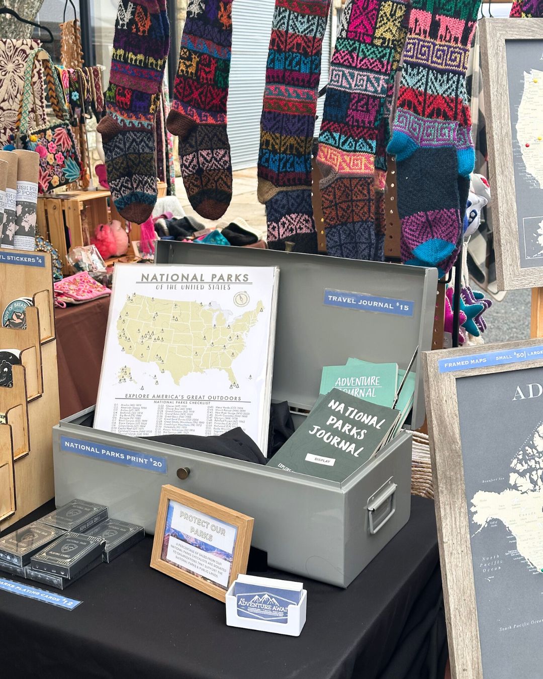 National parks map print displayed beneath rows of colorful knit socks.