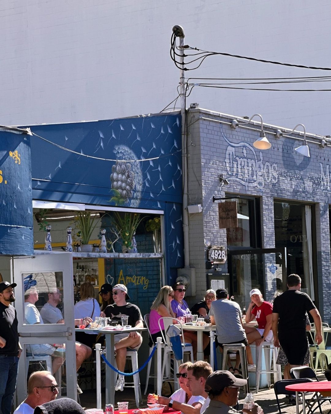 Outdoor restaurant patio at Gringos and Mariachis with seating along festival route