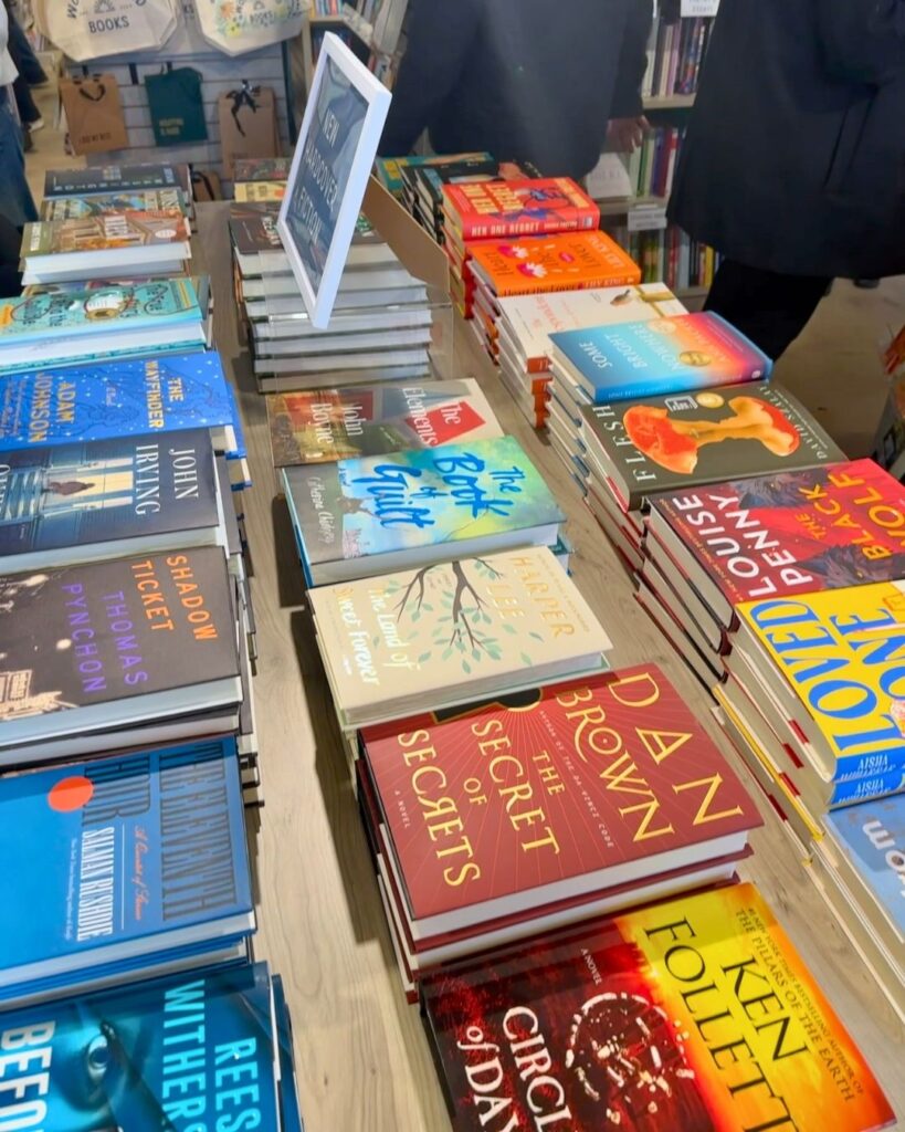 Display table stacked with new hardcover releases at Wonderland Books in Downtown Bethesda