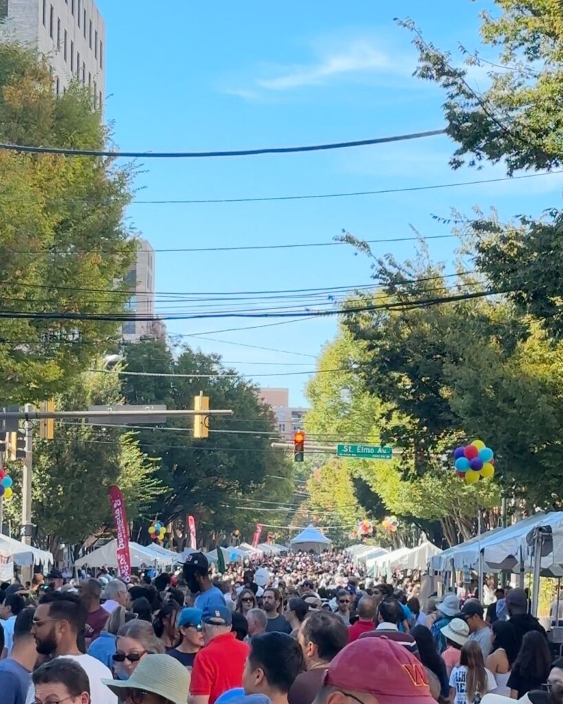 Large crowd filling Norfolk and St. Elmo Avenue intersection during Bethesda food festival