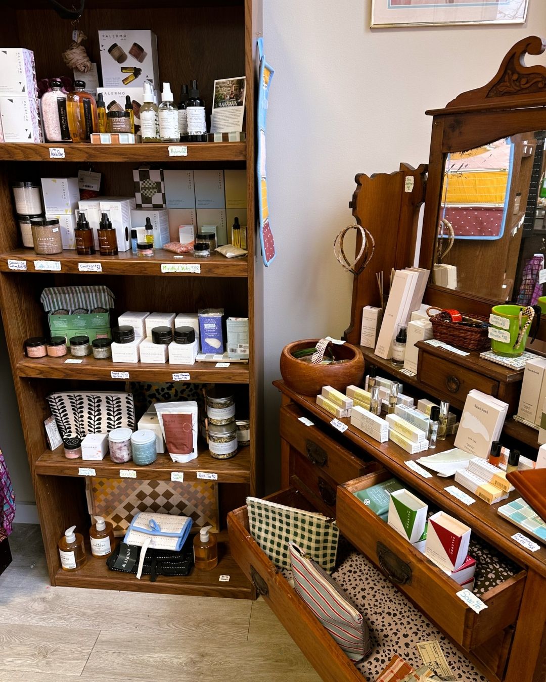 Wooden shelves and vintage furniture displaying natural sustainable skincare products, pouches, and beauty items in minimal packaging