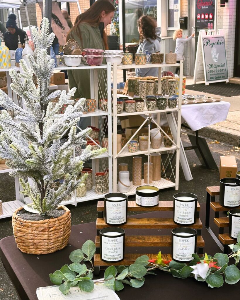 Close-up of eucalyptus and lavender candles displayed on wooden risers.