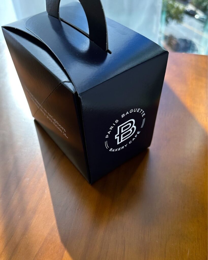 Navy Paris Baguette Bakery Cafe branded takeout box